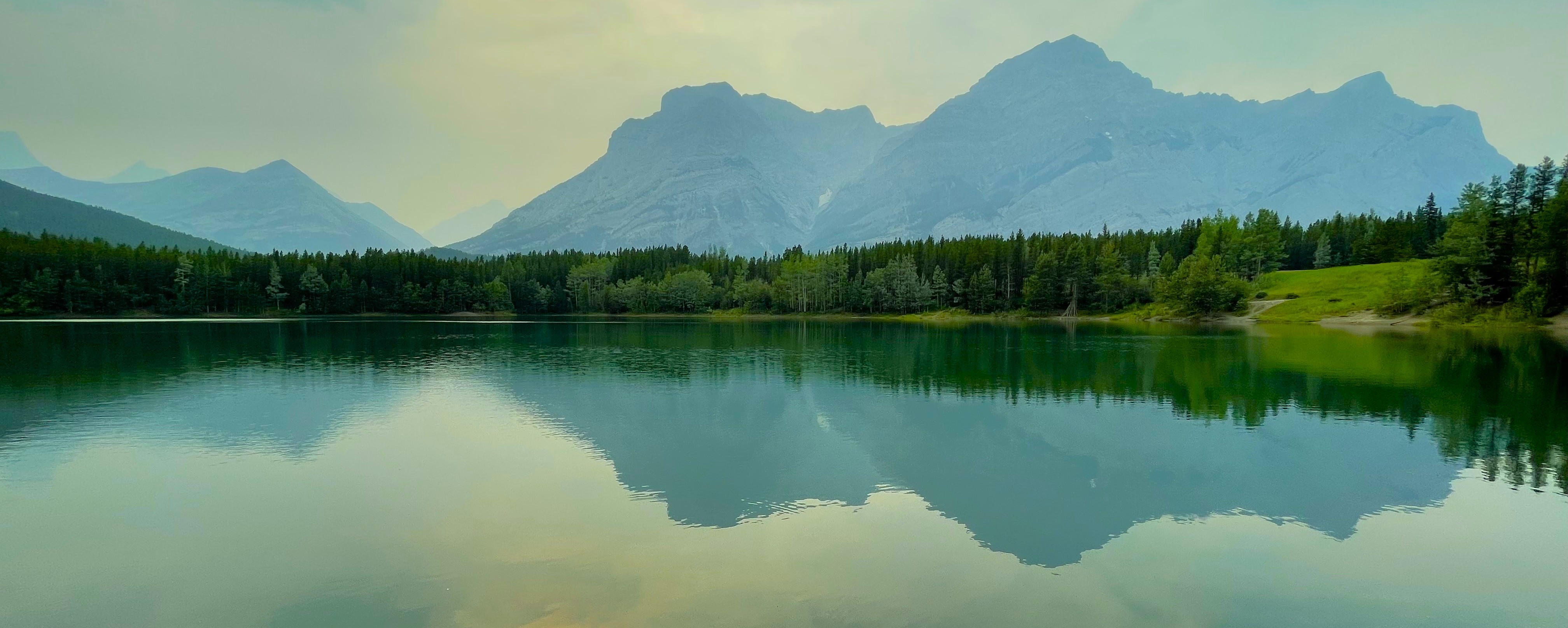 Mountains and forest reflected in a calm Canadian lake